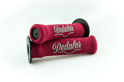 Garnet red knit grip covers with the Pedaler logo embossed in silver