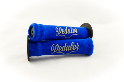 Royal blue knit grip covers with the Pedaler logo embossed in silver