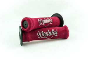 Garnet red knit grip covers with the "Pedaler" logo embossed in silver on a black rubber grip handle