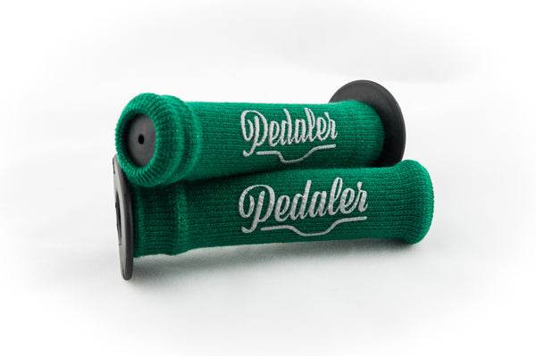 Forest green knit grip covers with the "Pedaler" logo embossed in silver on a black rubber grip handle