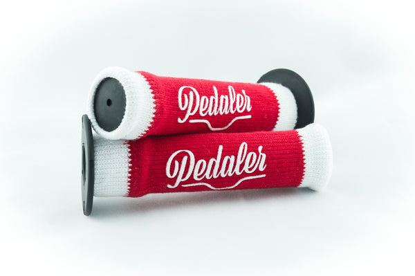 Red knit grip covers with white trim and the "Pedaler" logo embossed in white on a black rubber grip handle